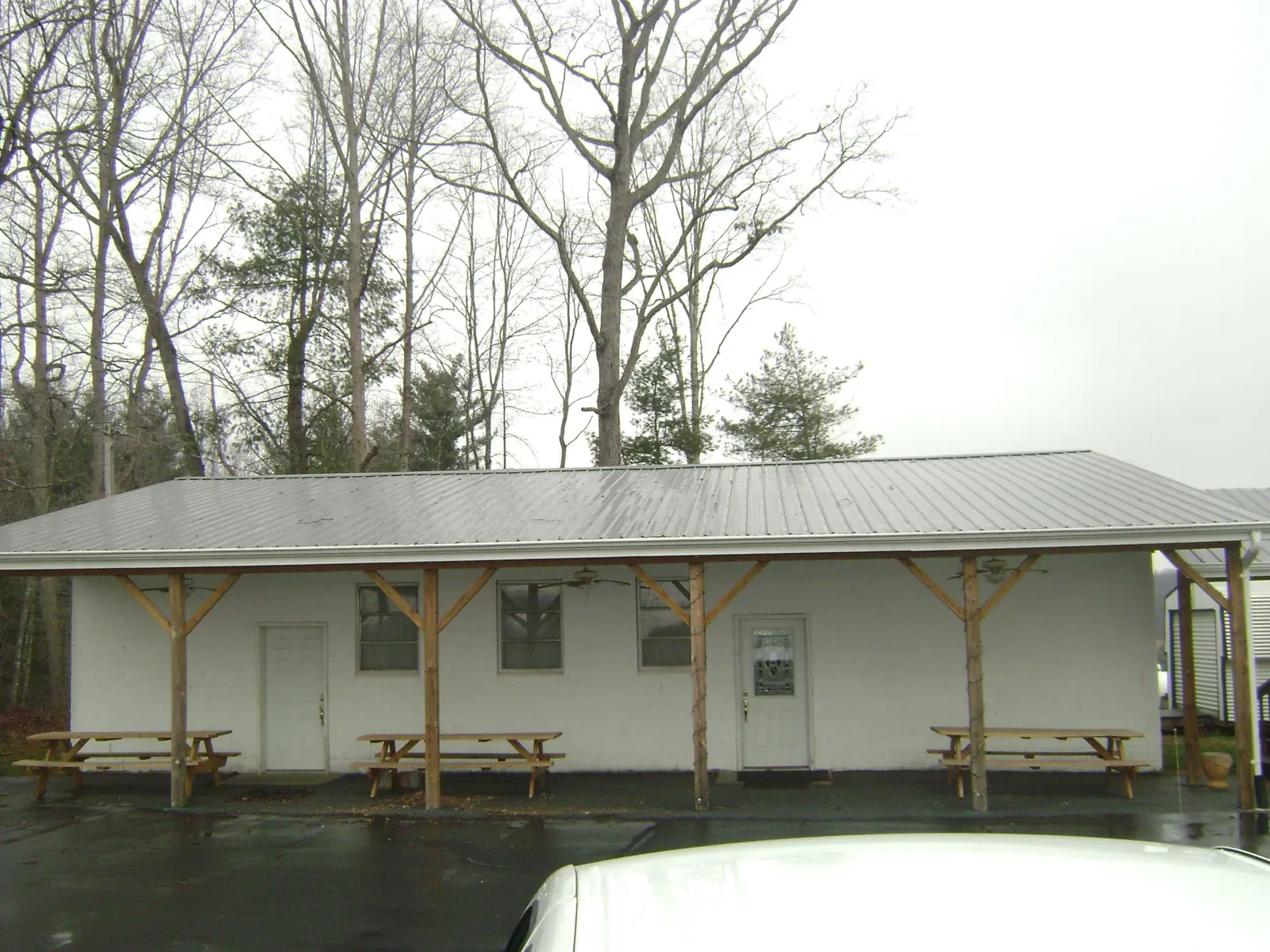 Gray metal roof over a block building with a timber post porch in Rocky Ford